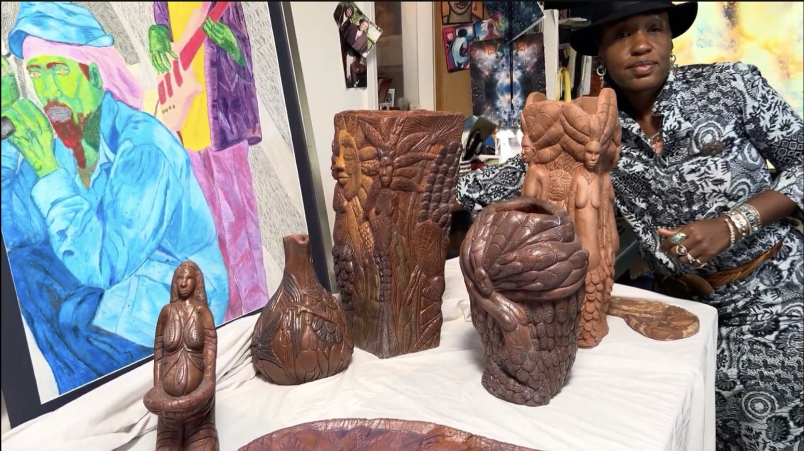 Ronda in her studio surrounded by her ceramic and carved sculptures